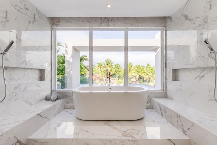 A modern bathroom with white marble surfaces providing a bright, clean look