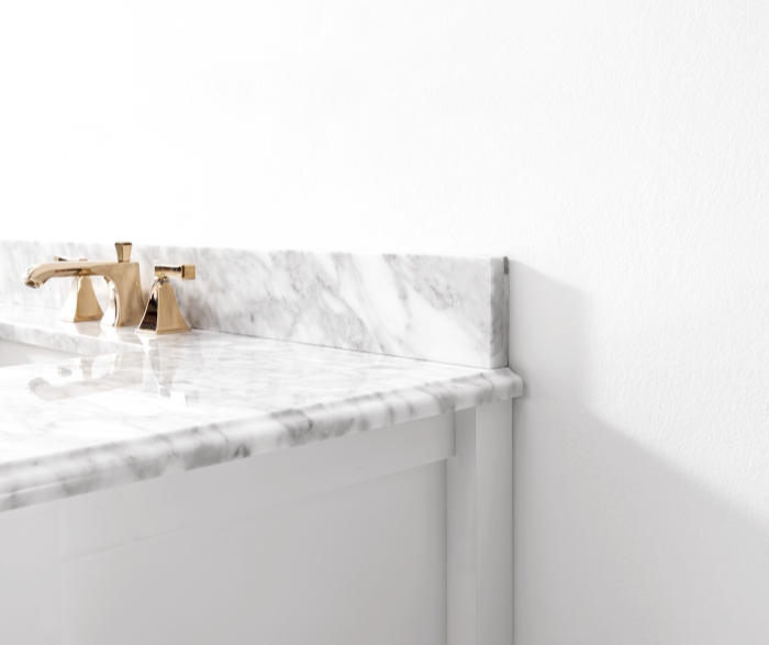 A stylish bathroom with a marble backsplash as a focal point