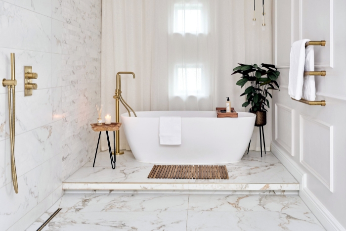 Bathroom featuring seamless marble flooring and shower area