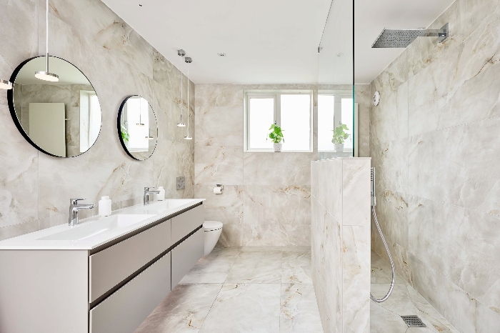 A bathroom featuring large marble tiles for a spacious effect